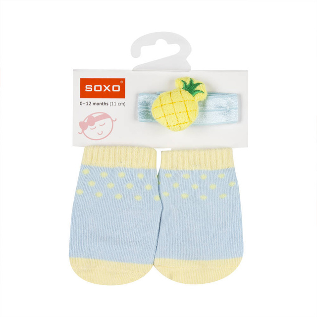 Un ensemble de chaussettes bébé SOXO bleues avec un bandeau à l'ananas